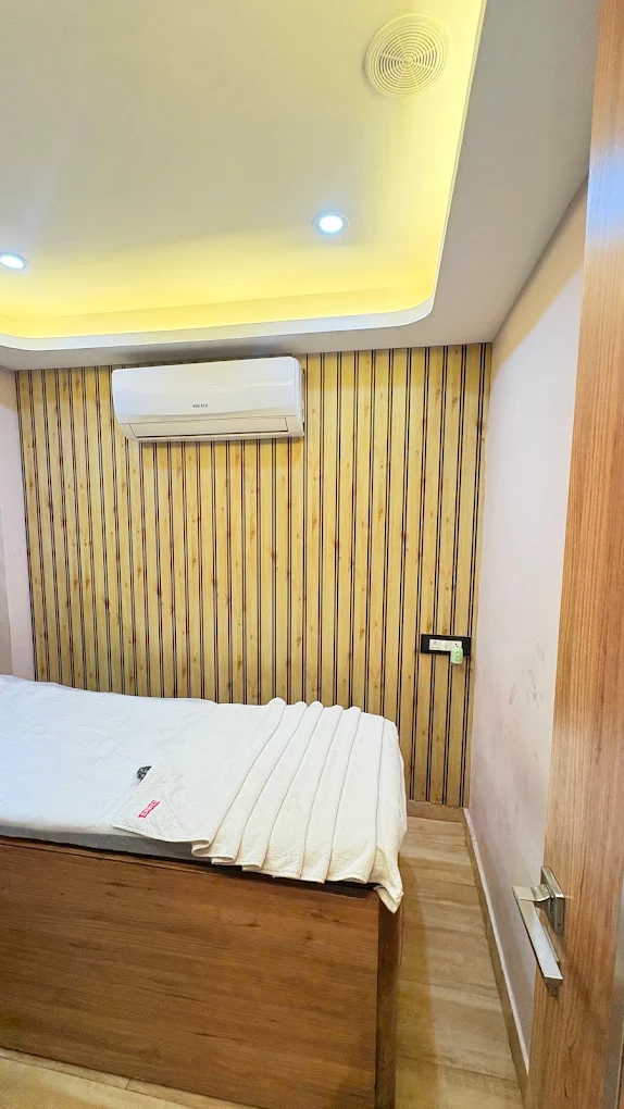 Cozy treatment bed with fresh linens at Morphosis Spa